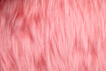 Luxurious pink faux fur background with long, wavy fibers creating a soft and fluffy texture. Ideal for fashion, upholstery, design, and decorative projects