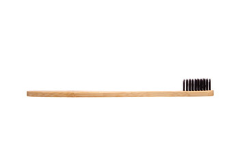 A biodegradable bamboo toothbrush with black bristles and a smooth, ergonomic handle, isolated on a white background. Ideal for sustainable oral hygiene and zero-waste living.