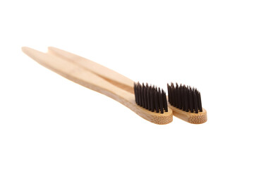 Two eco-friendly bamboo toothbrushes with black bristles, placed parallel on a white background. Sustainable, biodegradable, and plastic-free alternative for oral care