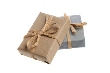 Two small rectangular gift boxes, one wrapped in brown kraft paper and the other in gray paper, both tied with rustic twine bows. Eco-friendly packaging on a white background