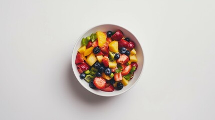 Top view of a fruit salad in a white bowl
