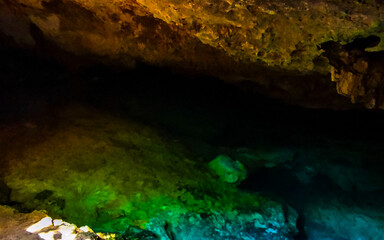 Cenote Park Yaxmuul with limestone rocks turquoise water and nature.