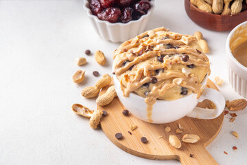 Healthy vegan Peanut Butter banana bread Mugcake, Rich and delicious peanut buttery microwave made mug cake with dates, chocolate drops, with Peanut Butter topping, nuts and chocolate