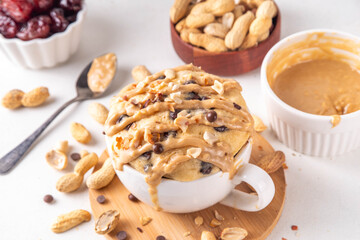 Healthy vegan Peanut Butter banana bread Mugcake, Rich and delicious peanut buttery microwave made mug cake with dates, chocolate drops, with Peanut Butter topping, nuts and chocolate