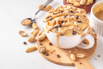 Healthy vegan Peanut Butter banana bread Mugcake, Rich and delicious peanut buttery microwave made mug cake with dates, chocolate drops, with Peanut Butter topping, nuts and chocolate