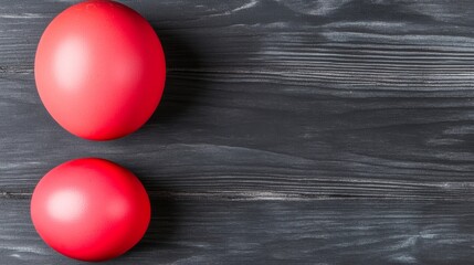 Two Red Easter Eggs on Dark Wooden Surface