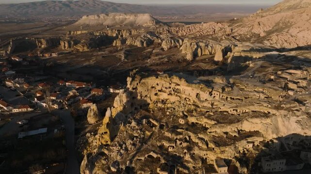 Drone view of the &Ccedil;avuşin Kalesi castle caves in the sunset rays in Cappadocia
