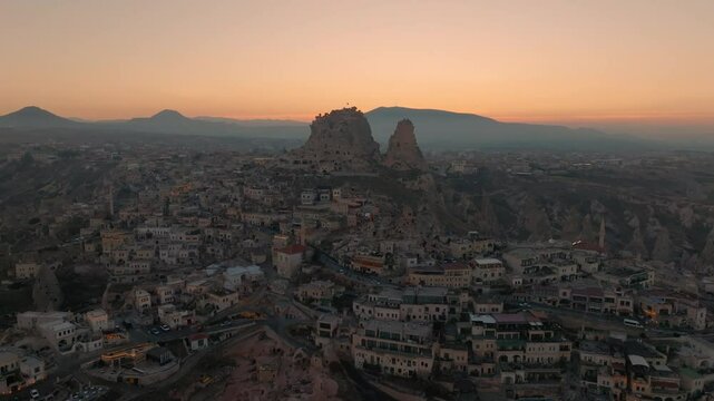 Aerial view of Uchisar Castle, pierced with caves, during sunset in Cappadocia