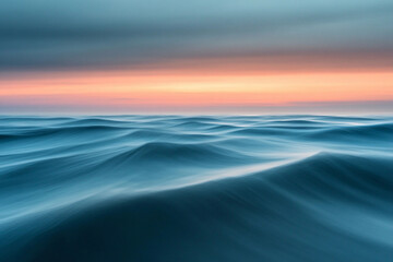 Obraz premium Sunset over calm ocean waters creates a serene atmosphere with vibrant colors on the horizon