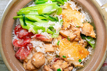 top view clay pot rice of chicken and Chinese style sausage and vegetable at horizontal composition
