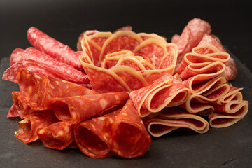 Different kinds of meat cuts on a board.