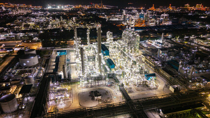 Fototapeta premium Illuminated Industrial Refinery at Night