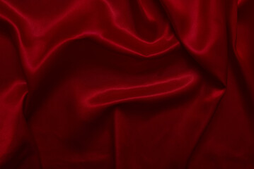 The top view of the red satin surface looks luxurious and beautiful. with sparkling waves Abstract background design copy space Card or banner (blurred or blurry)