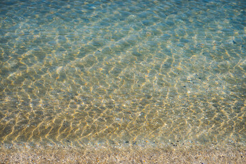 Clear Shallow Seawater with Sunlight Reflections..