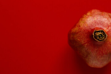 ripe pomegranate on red background 