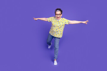 Smiling elderly woman with short grey hair wearing casual floral shirt against purple background, exploring youthful expressions and poses.