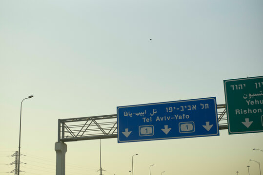 Road signs on a highway directing to Tel Aviv under a clear sky. Israel