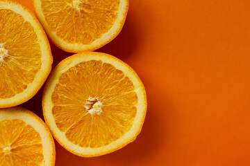 round slice of fresh orange fruit on orange background