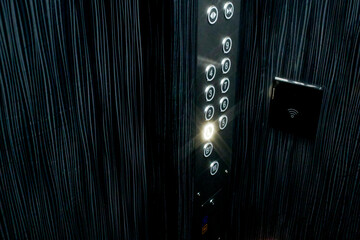 Close-up of a modern elevator control panel with illuminated buttons. Tokyo, Japan