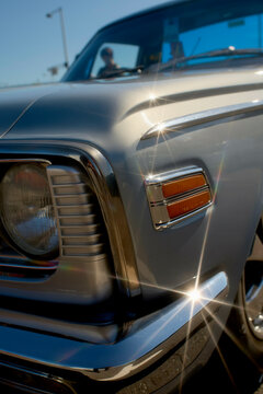 Close-up of a classic car's shiny chrome details under bright sunlight. Tokyo, Japan