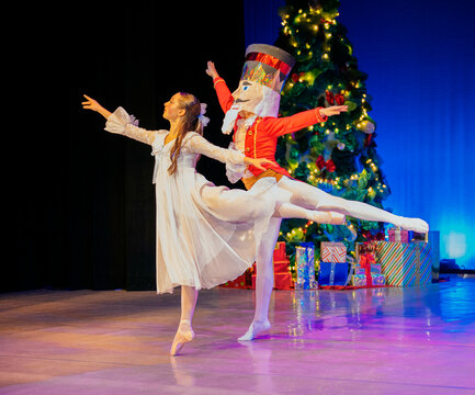Ballerina dancing with a performer in a nutcracker costume on a festive stage. The Nutcracker, Bainbridge Island, USA