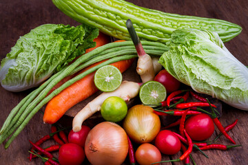 Fresh fruit and fresh vegetables on an old wooden table.