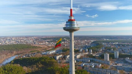 Giant tricolor Lithuanian flag waving on Vilnius television tower on the celebration of restoration of Independence of Lithuania on the 11th of March. Orbit view.
