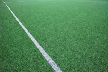 Green sports field with white boundary line