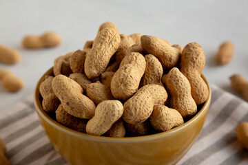 Organic Raw Peanuts in a Bowl, low angle view. Close-up.