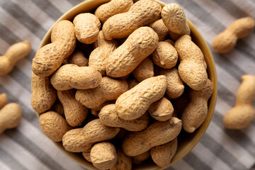Organic Raw Peanuts in a Bowl, top view.