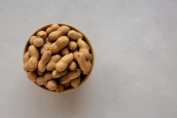 Organic Raw Peanuts in a Bowl, top view. Copy space.