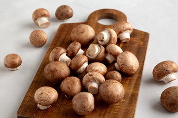 Raw Royal Brown Champignon on a wooden board, side view.