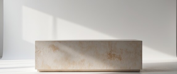 Podium made of stone for showcasing products with a white backdrop.