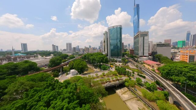 Cinematic FPV flight over LRT train track and Kuala Lumpur city skyline, Malaysia