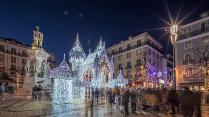 Naklejka premium Night timelapse hyperlapse of Christmas decorations with illuminated castle on Luis de Camoes square in Lisbon, Portugal.