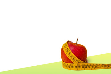 Red apple and tape measure centimetre around the fruit. White background 