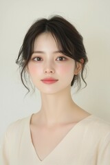 Fototapeta premium Elegant Young Woman in Soft Pastel Dress with Natural Makeup