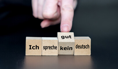 Hand turns cube and changes the German expression 'ich spreche kein deutsch' ( I do not speak...