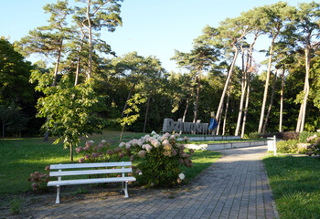 Dziwnow, Poland, public park near the baltic sea with benches and a town sign