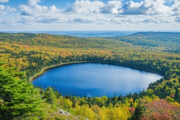 Scenic aerial view of tranquil lake surrounded by vibrant autumn foliage and rolling hills