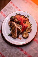 Restaurant dish fish with vegetables: zucchini, pepper