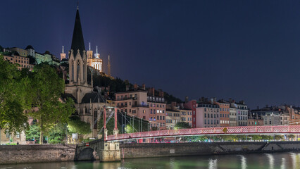 Timelapse hyperlapse of Saint George Church at night, Quais de Saone and Fourviere Basilica from a footbridge in Vieux Lyon, France