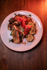 Restaurant dish fish with vegetables: zucchini, pepper