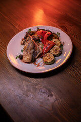 Restaurant dish fish with vegetables: zucchini, pepper