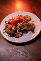 Restaurant dish fish with vegetables: zucchini, pepper