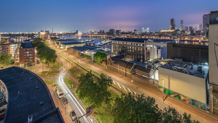 Obraz premium Aerial panoramic view over towers in Maashaven night to day timelapse in Rotterdam