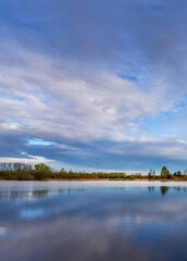 Calm lake with a cloudy sky in the background