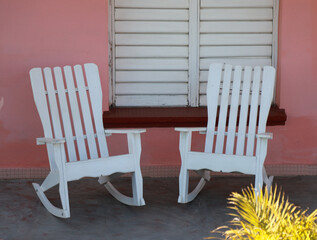 multiple vintage rocking chairs in front of colorful wall