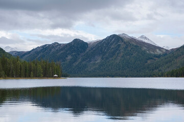 Autumn mountains are reflected in the lake, Rakhmanovskie Klyuchi, Altai in Kazakhstan