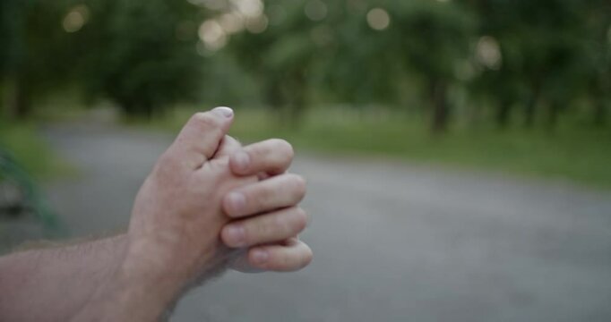 Close-up of a man cracking his knuckles and fingers, emphasizing hand mobility, flexibility, and joint health.